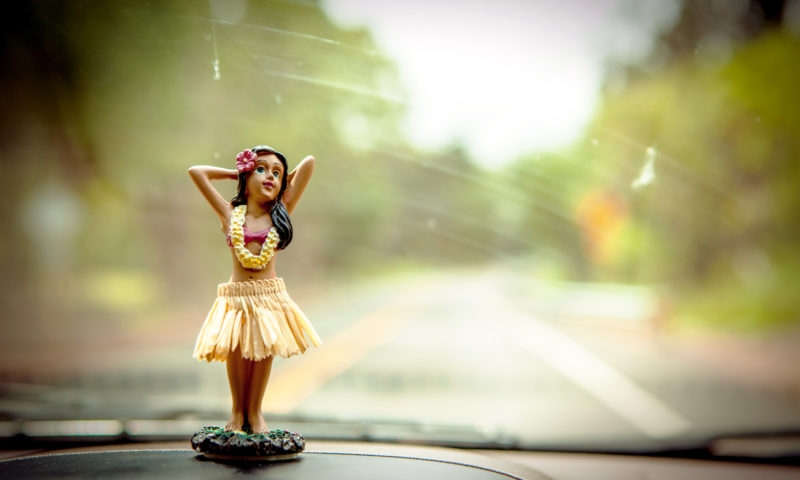 dashboard of car with bobbing figure