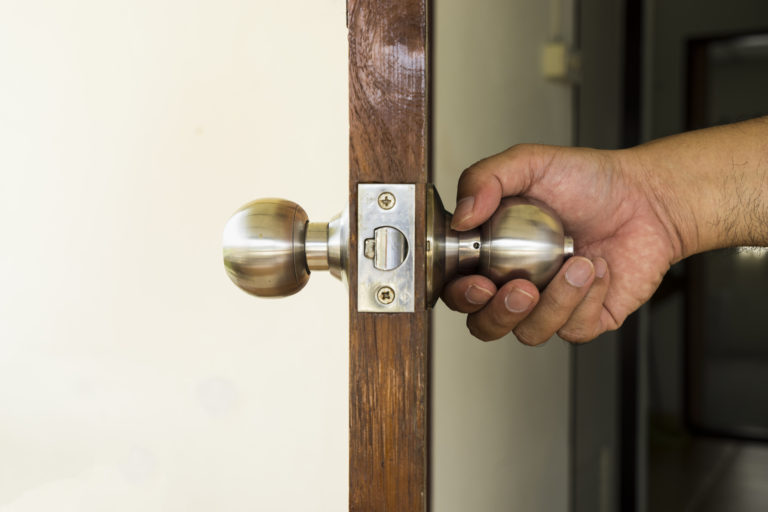 person turning door knob Thomas Smith Insurance Agency