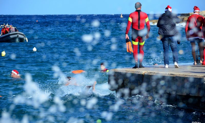 swimmers getting ready to jump during the christmas charity swim