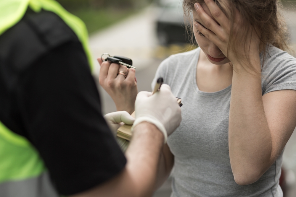 women with policeman looking worried after a breathalyser test