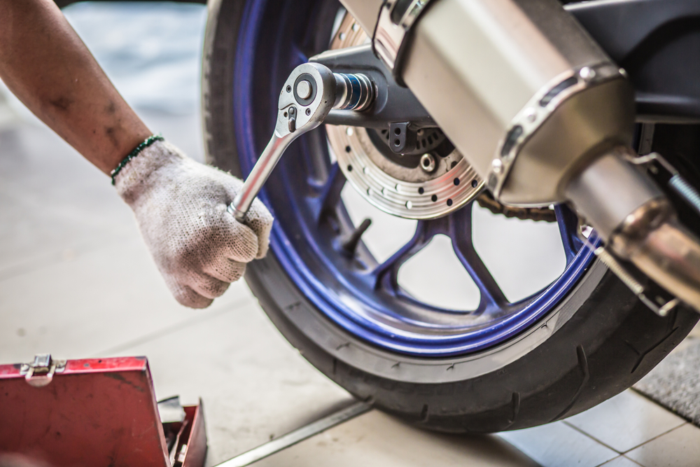 mechanic fixing motorcycle tyre