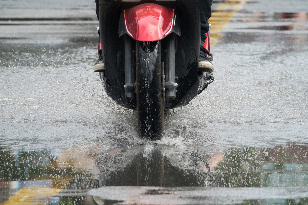 motorcyle driven in the rain with roads washed with water